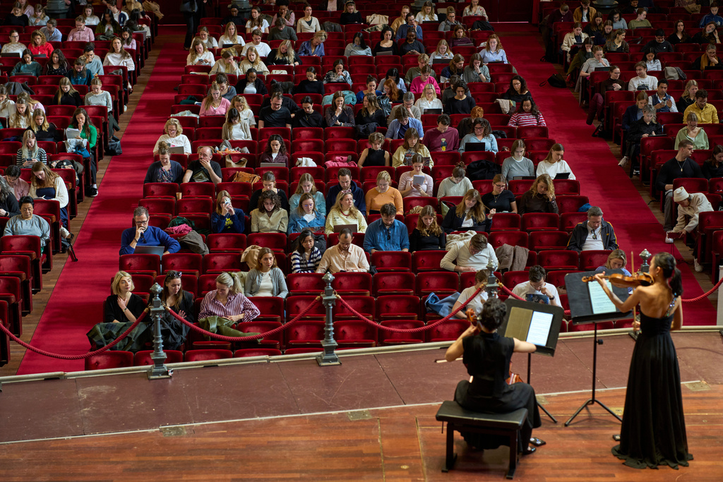 Students in Amsterdam study while musicians play